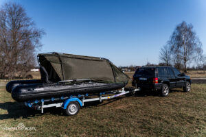 Rozłożony namiot wędkarski Black Cat Special Boat Cave II na pontonie, zapewniający ochronę przed deszczem i wiatrem na wodzie - oferta sklepu KOMPAS BOATS